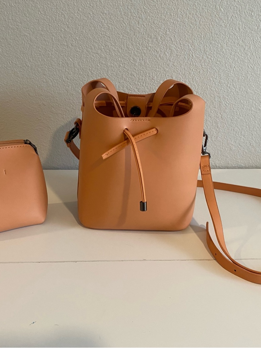 Anthropologie Minimalist Bucket Crossbody Bag in Peach Tan